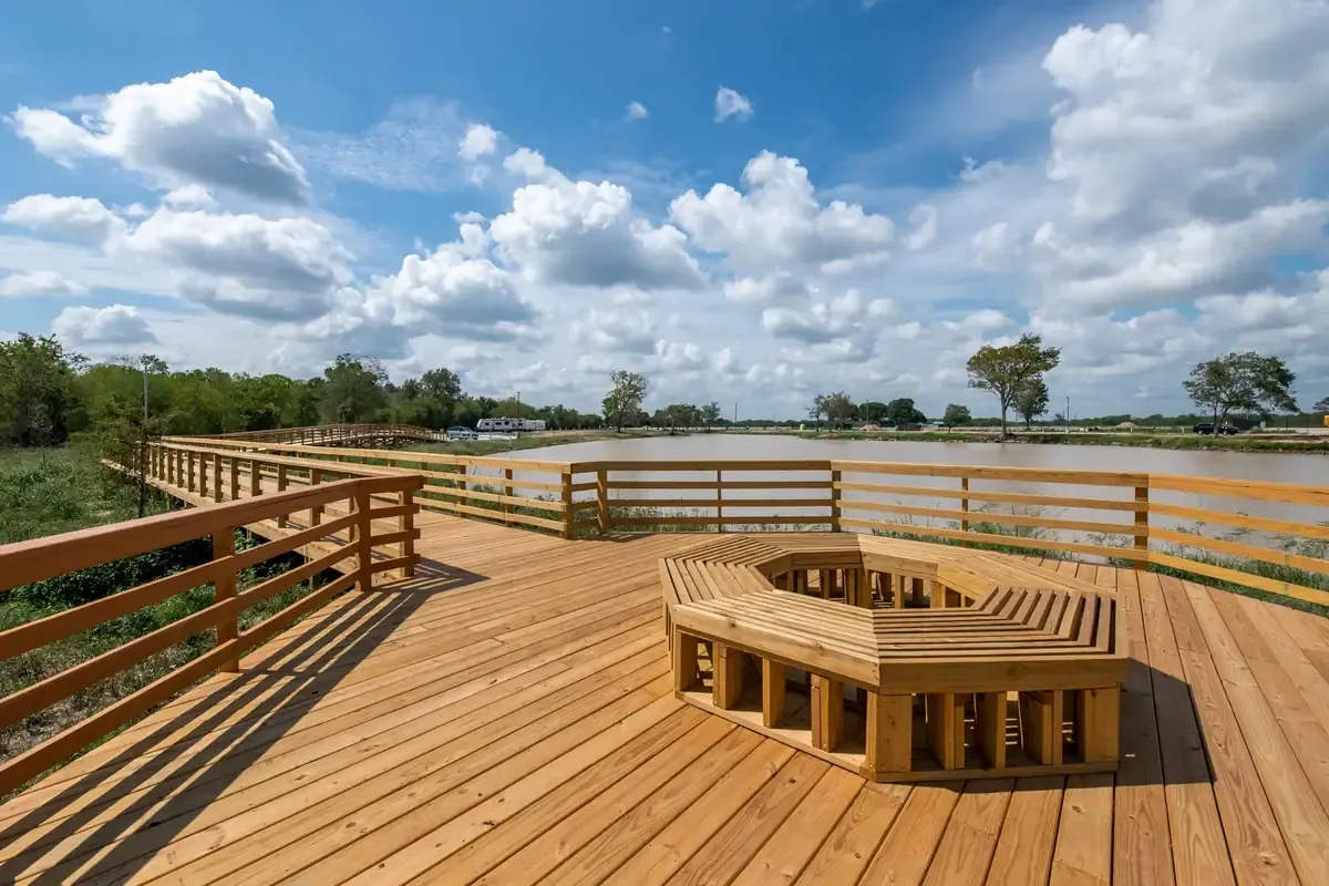 Wood deck and railing overlooking a pond